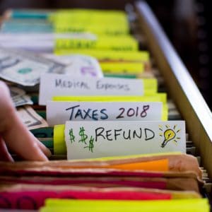 colorful files with tab showing "taxes" and "refund"